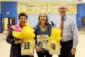 Source: The Leader News, Harvard Elementary Principal Kevin Beringer with Raiza Jan (left) and Elizabeth Suneby (center)